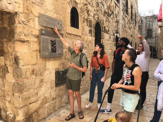 Students inspecting a plaque in Israel 