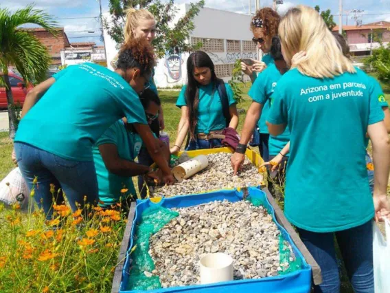 students with containers of small rocks