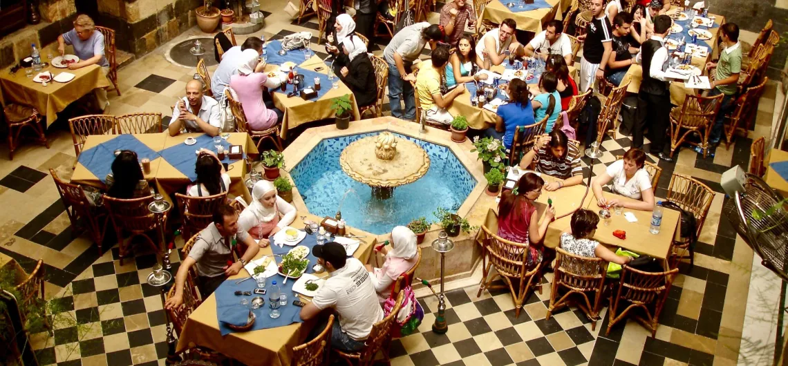 Large group of people eating Middle Eastern food