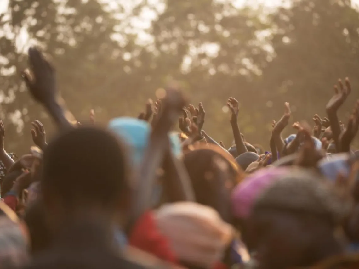 many people raising their hands